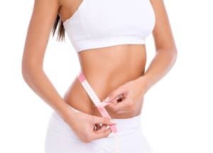 Woman in conservative white underwear is pleased with her trimmer physique.
