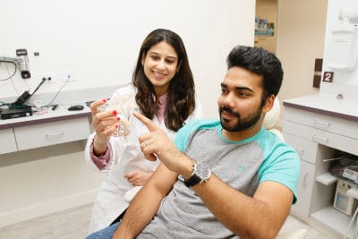 Doctor showing patient all-on-4 implants