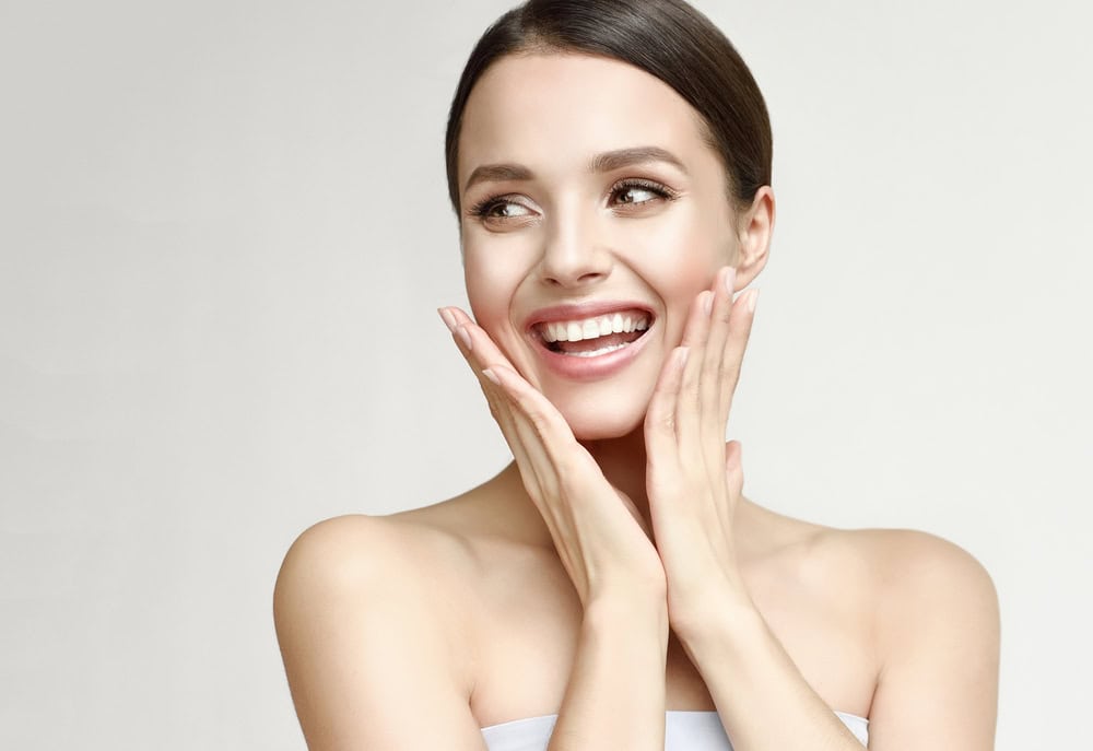 Woman enjoys her smooth, radiant skin after treatments performed by medical aestheticians.