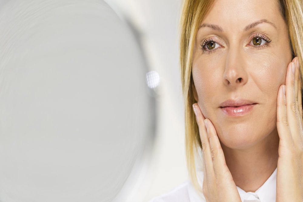 Middle aged woman has rejuvenated forehead and eyes after cosmetic surgery