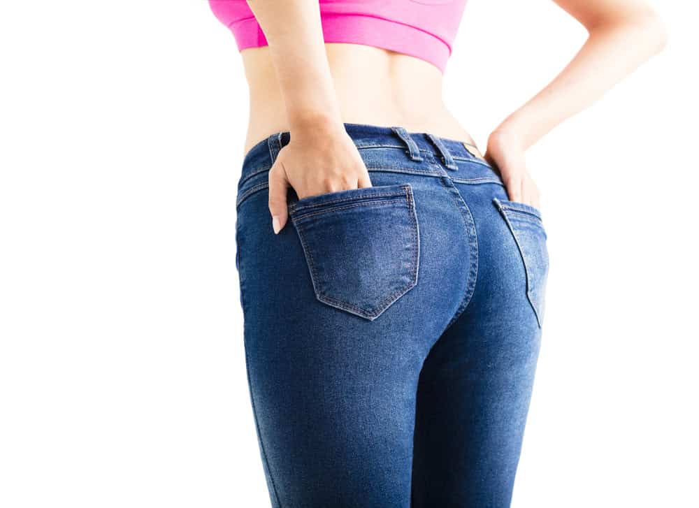 Woman with pronounced buttocks wears a tight pair of jeans.