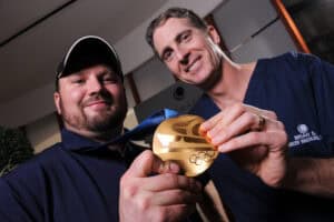 Dr. Brian and Olympic gold medalist Steven Holcomb with historic gold – Holcomb C3-R® was named in Steven’s honor after his victory.