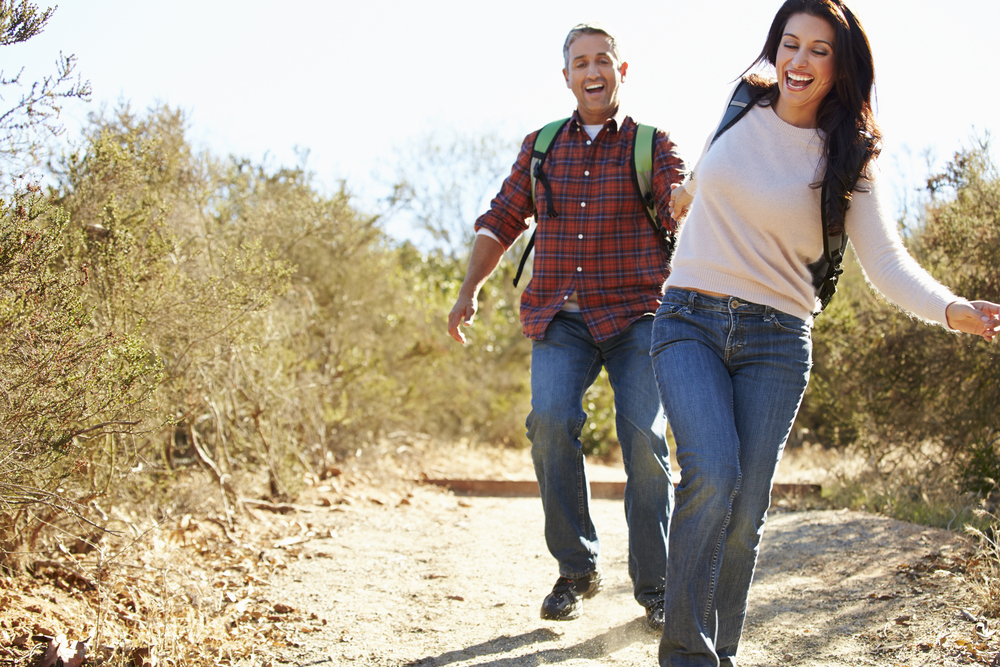 Romantic couple in their 50s goes for a hike, happy with their current energy levels