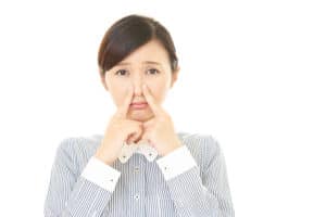 photo of teenage girl touching her nose and frowning | Maloney Center for Facial Plastic Surgery