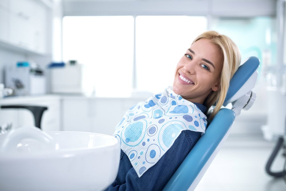 Blonde woman at dentist is seeking a more transformative restorative procedure.