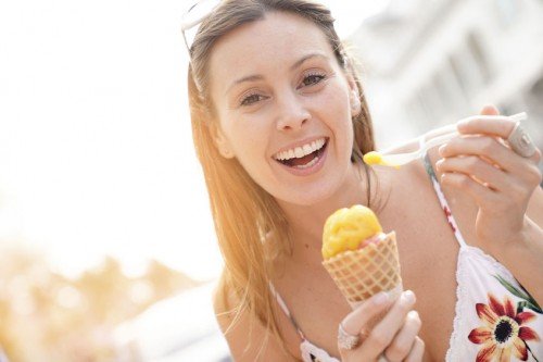 Girl smiling and eating ice cream