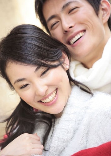 Young couple laughing and hugging