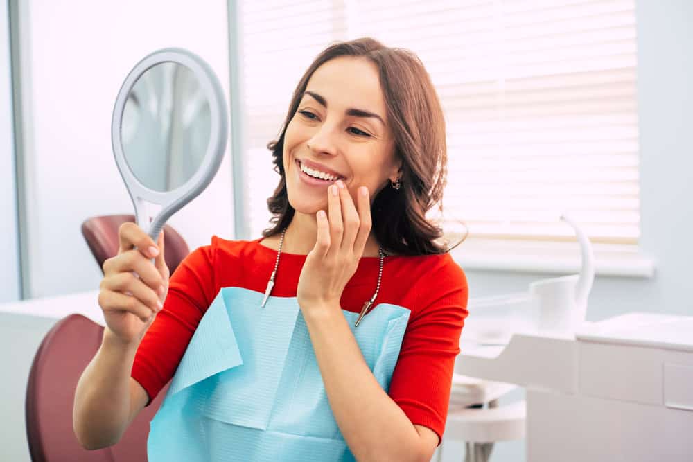 Woman after dental implants in Seattle, WA