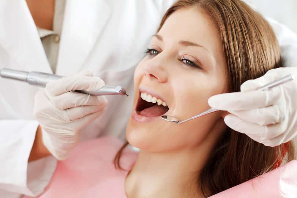 Dentist examining periodontal pockets in Seattle, WA