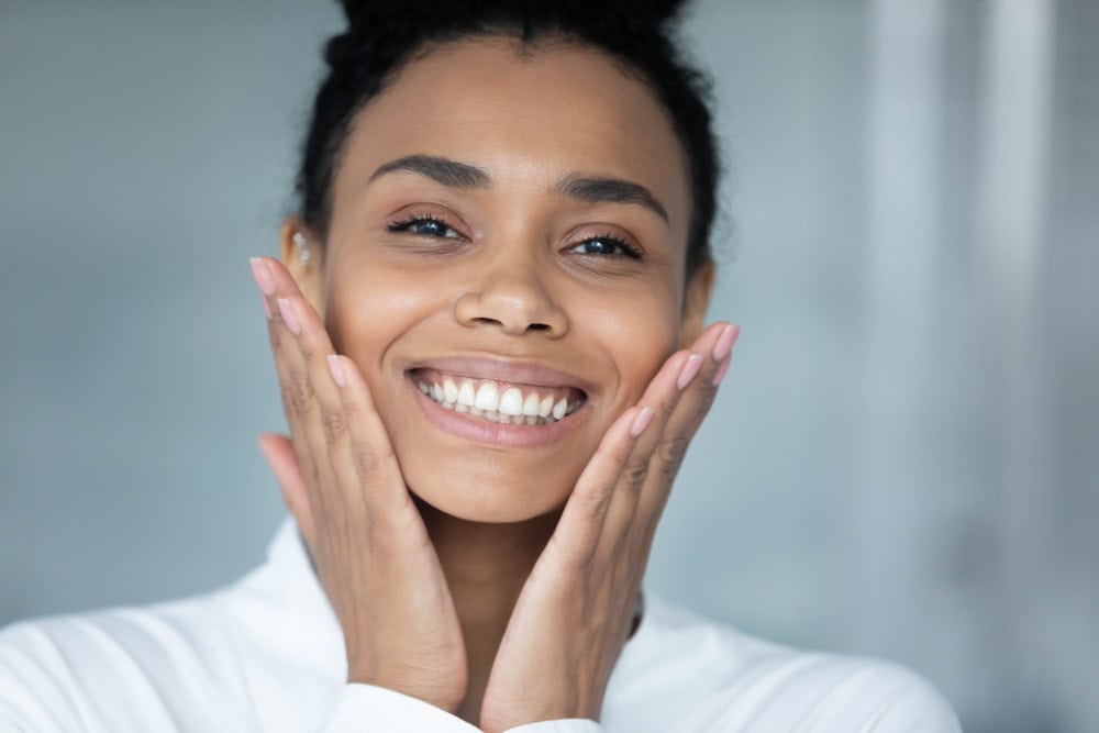 Woman smiling after soft tissue grafting in Seattle