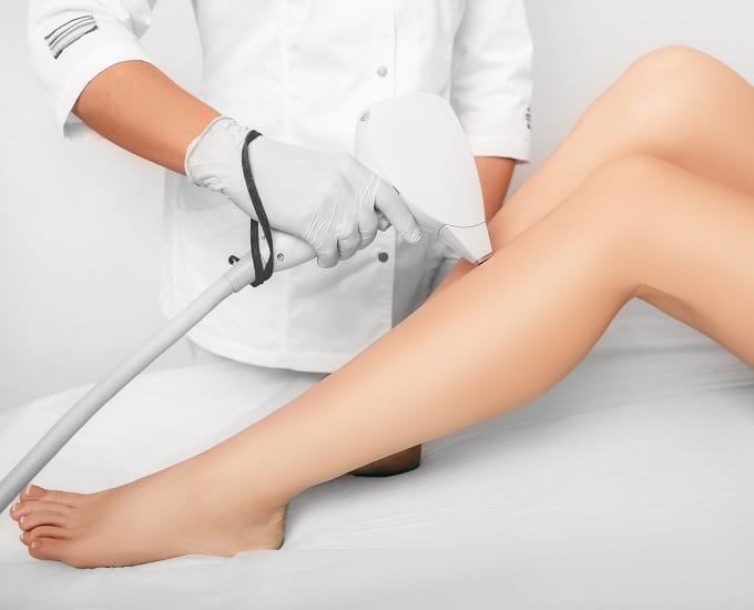 Beautician,Removes,Hair,On,Beautiful,Female,Legs,Using,A,Laser.