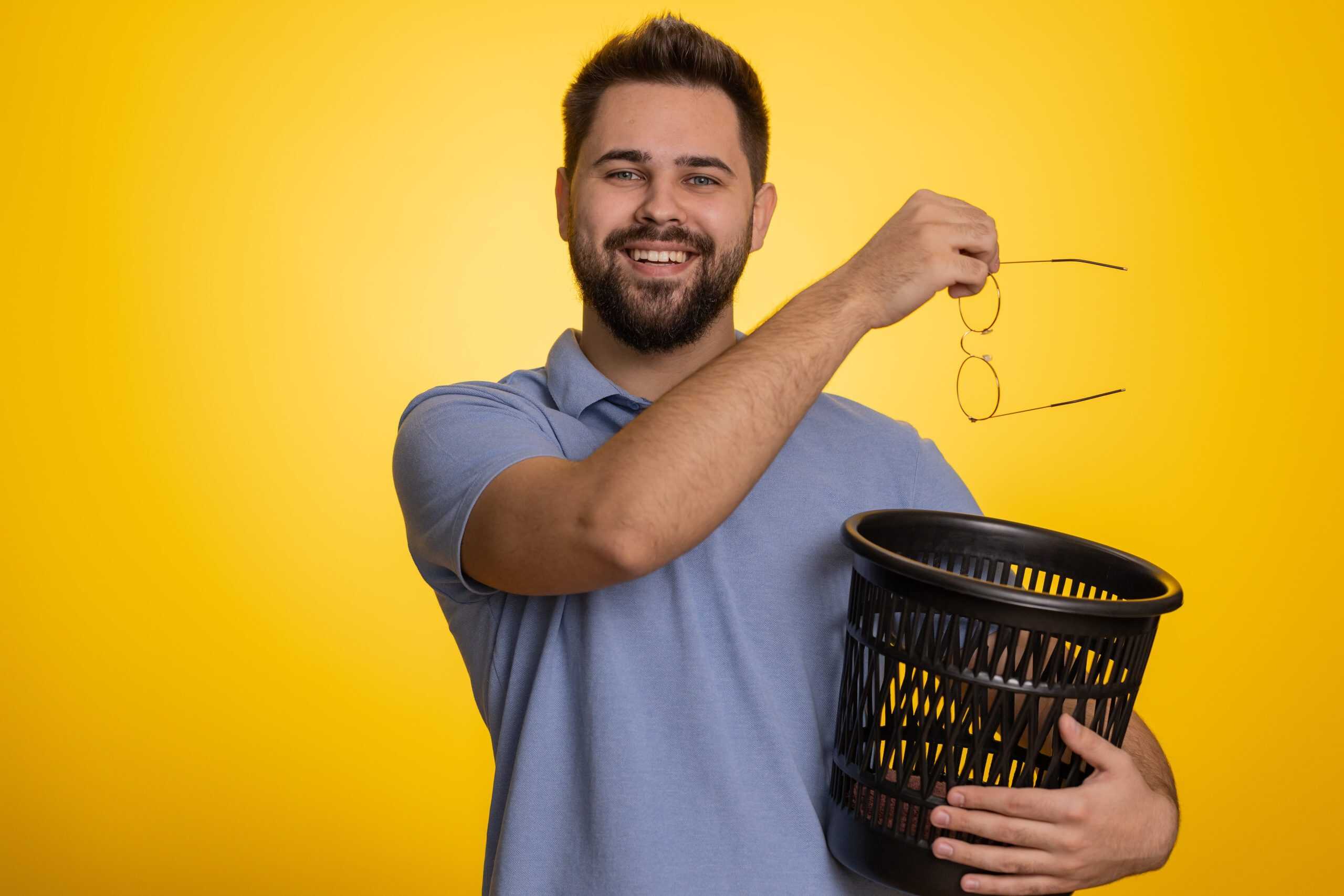 Man throwing away his glasses after PRK vision correction surgery
