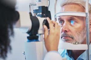 Man in his 50s has his eyes checked by an eye doctor in Florida.