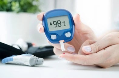 Person checks their blood sugar level to monitor diabetes.