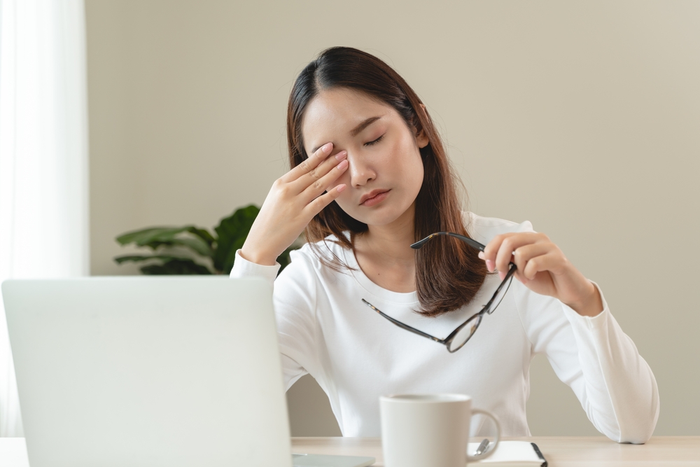 Woman rbbing dry eyes in need of treatmetn in Boston
